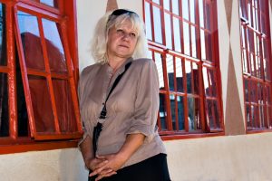 casual middle age woman against red windows. People diversity series